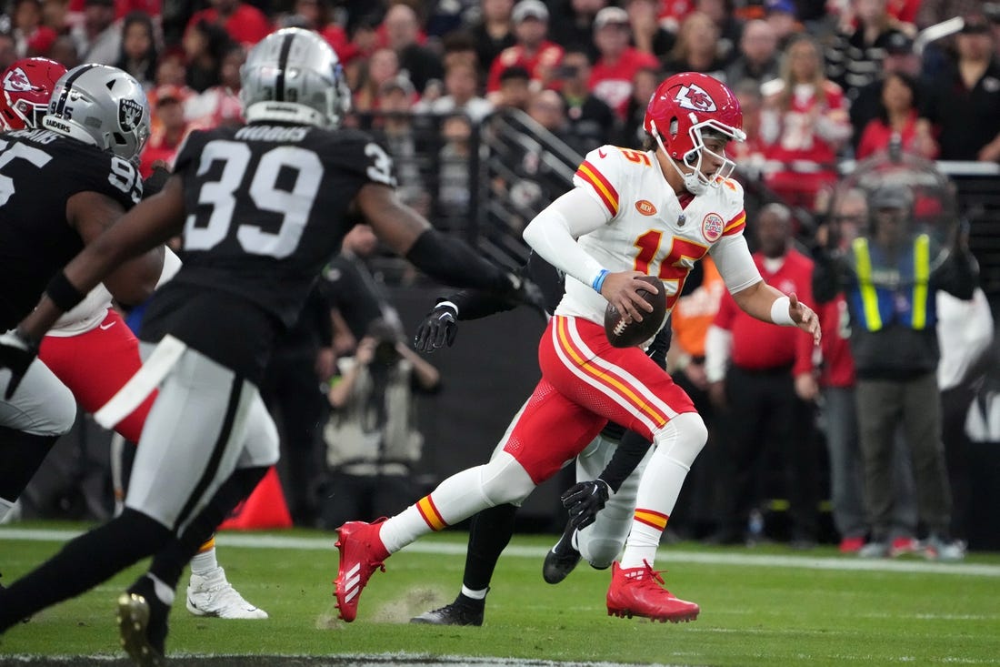 Nov 26, 2023; Paradise, Nevada, USA; Kansas City Chiefs quarterback Patrick Mahomes (15) carries the ball against the Las Vegas Raiders in the first half at Allegiant Stadium. Mandatory Credit: Kirby Lee-USA TODAY Sports