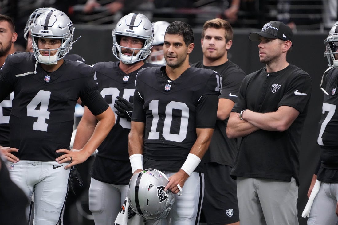 Aug 13, 2023; Paradise, Nevada, USA; Las Vegas Raiders quarterback Jimmy Garoppolo (10) and quarterback Aidan O'Connell (4) watch from the sidelines against the San Francisco 49ers in the first half at Allegiant Stadium. Mandatory Credit: Kirby Lee-USA TODAY Sports