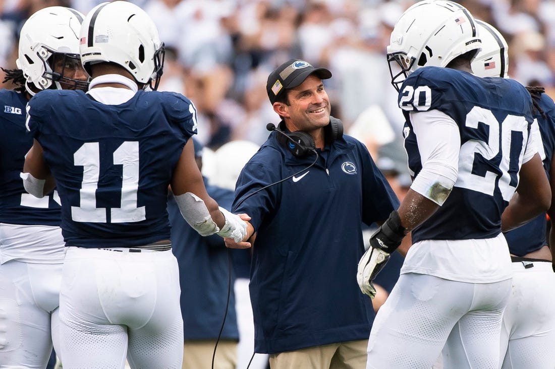 Penn State defensive coordinator Manny Diaz grins as his unit comes to the sideline after creating a turnover late in the the second half of an NCAA football game against Indiana at Beaver Stadium Saturday, Oct. 28, 2023, in State College, Pa.