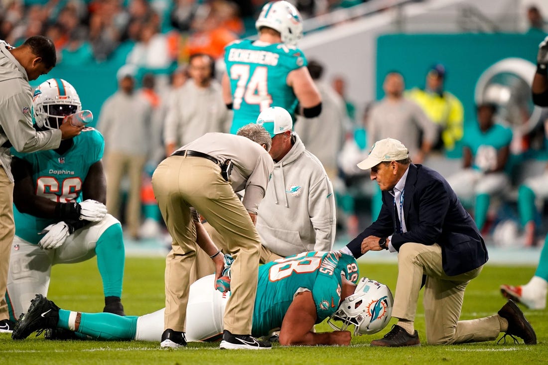 Miami Dolphins guard Connor Williams (58) is check out by staff during the first quarter against the Tennessee Titans at Hard Rock Stadium in Miami, Fla., Monday, Dec. 11, 2023.