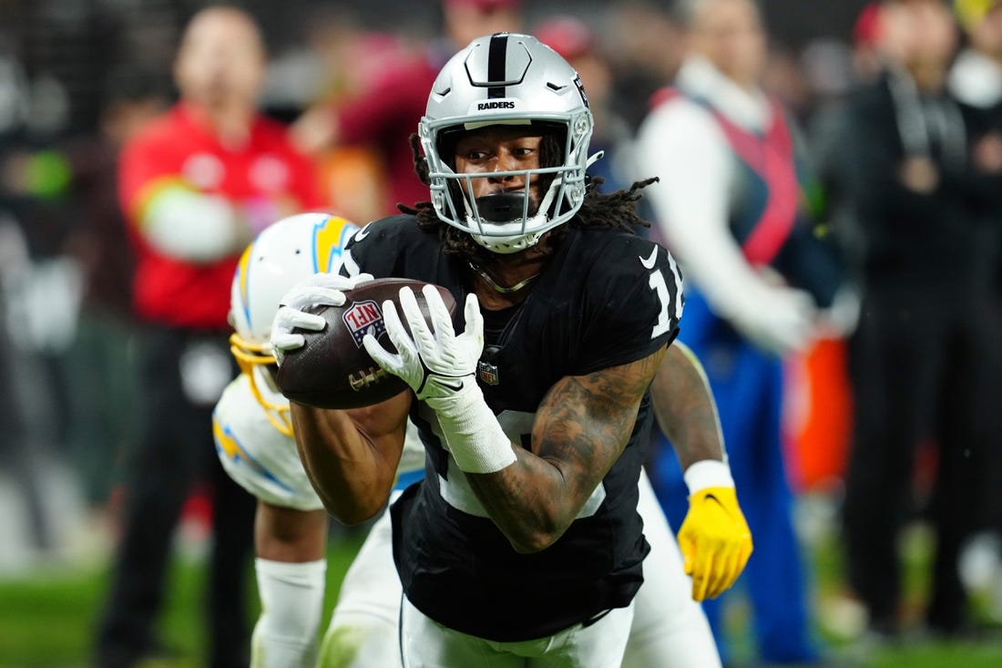 Dec 14, 2023; Paradise, Nevada, USA;  Las Vegas Raiders wide receiver Jakobi Meyers (16) makes a catch for a touchdown against the Los Angeles Chargers in the first quarter at Allegiant Stadium. Mandatory Credit: Stephen R. Sylvanie-USA TODAY Sports