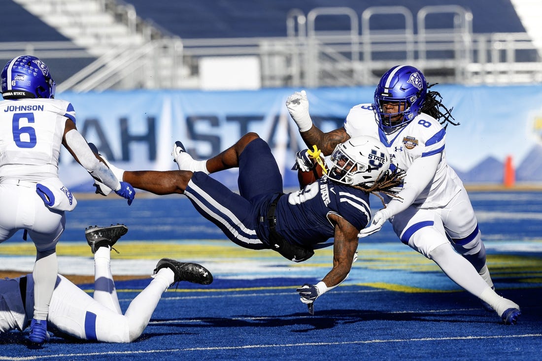 Dec 23, 2023; Boise, ID, USA; Utah State Aggies running back Rahsul Faison (3) is tackled during the first half against the Georgia State Panthers at Albertsons Stadium. Mandatory Credit: Brian Losness-USA TODAY Sports
