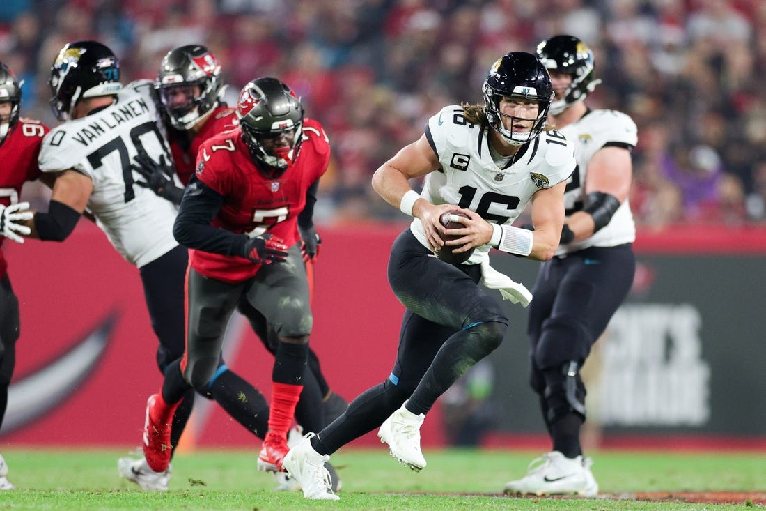Dec 24, 2023; Tampa, Florida, USA;  Jacksonville Jaguars quarterback Trevor Lawrence (16) runs with the ball against the Tampa Bay Buccaneers in the third quarter at Raymond James Stadium. Mandatory Credit: Nathan Ray Seebeck-USA TODAY Sports