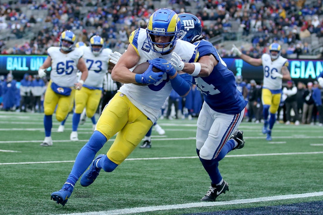 Dec 31, 2023; East Rutherford, New Jersey, USA; Los Angeles Rams wide receiver Cooper Kupp (10) scores a touchdown against New York Giants cornerback Nick McCloud (44) during the second quarter at MetLife Stadium. Mandatory Credit: Brad Penner-USA TODAY Sports