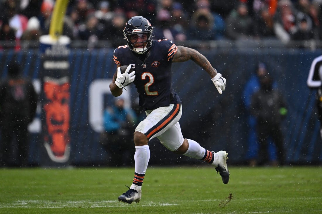 Dec 31, 2023; Chicago, Illinois, USA;  Chicago Bears wide receiver DJ Moore (2) runs with the ball after a catch in the second half against the Atlanta Falcons at Soldier Field. Mandatory Credit: Jamie Sabau-USA TODAY Sports