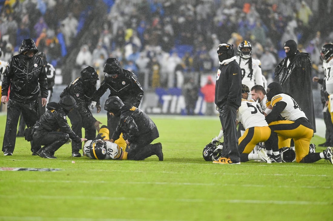 Jan 6, 2024; Baltimore, Maryland, USA;  Pittsburgh Steelers medical staff tend to inebacker T.J. Watt (left) as teammates take a knee during the third  quarter against the Baltimore Ravens at M&T Bank Stadium. Mandatory Credit: Tommy Gilligan-USA TODAY Sports