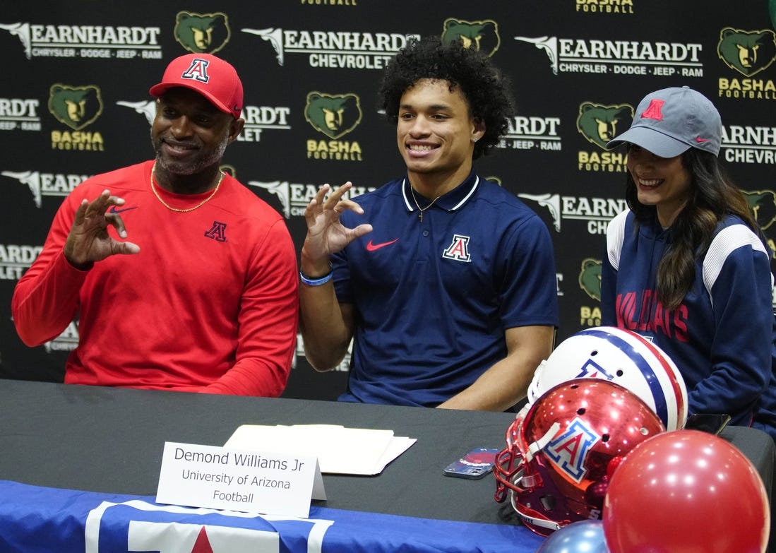 Basha quarterback Demond Williams poses for pictures after signing his letter of intent to play for University of Arizona during the NLI signing at Basha High School in Chandler on Dec. 20, 2023.