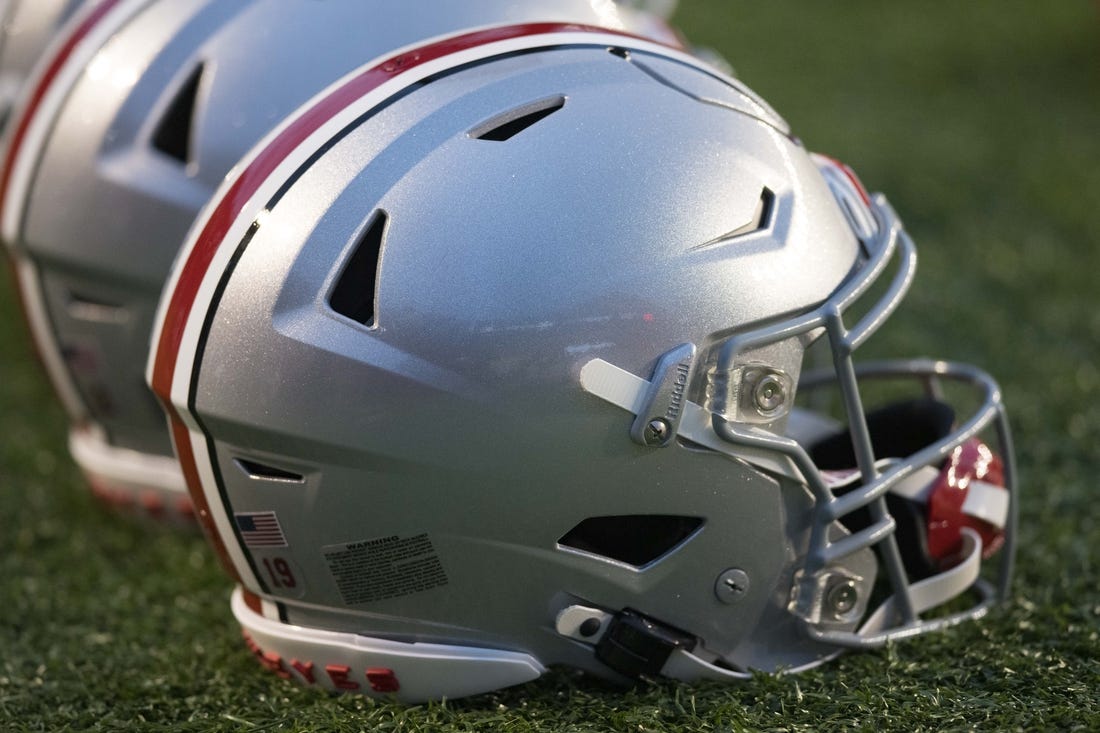 Oct 28, 2023; Madison, Wisconsin, USA;  Ohio State Buckeyes helmets sit on the field during warmups prior to the game against the Wisconsin Badgers at Camp Randall Stadium. Mandatory Credit: Jeff Hanisch-USA TODAY Sports