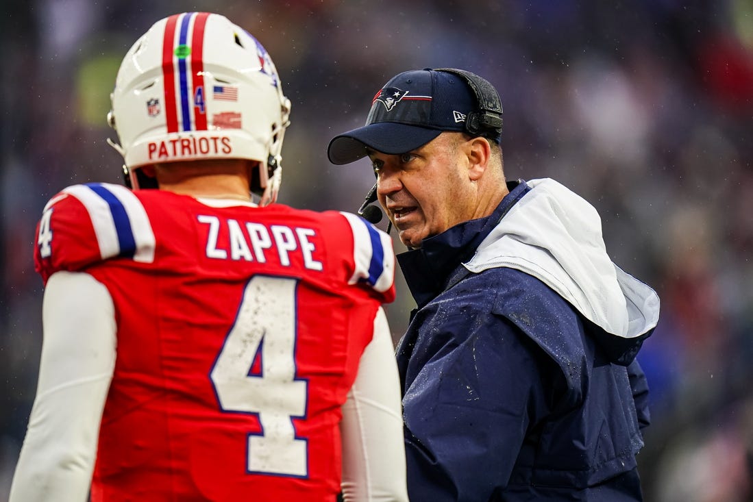 Dec 3, 2023; Foxborough, Massachusetts, USA; New England Patriots offensive coordinator Bill O'Brien talks with quarterback Bailey Zappe (4) as they take on the Los Angeles Chargers in the second quarter at Gillette Stadium. Mandatory Credit: David Butler II-USA TODAY Sports