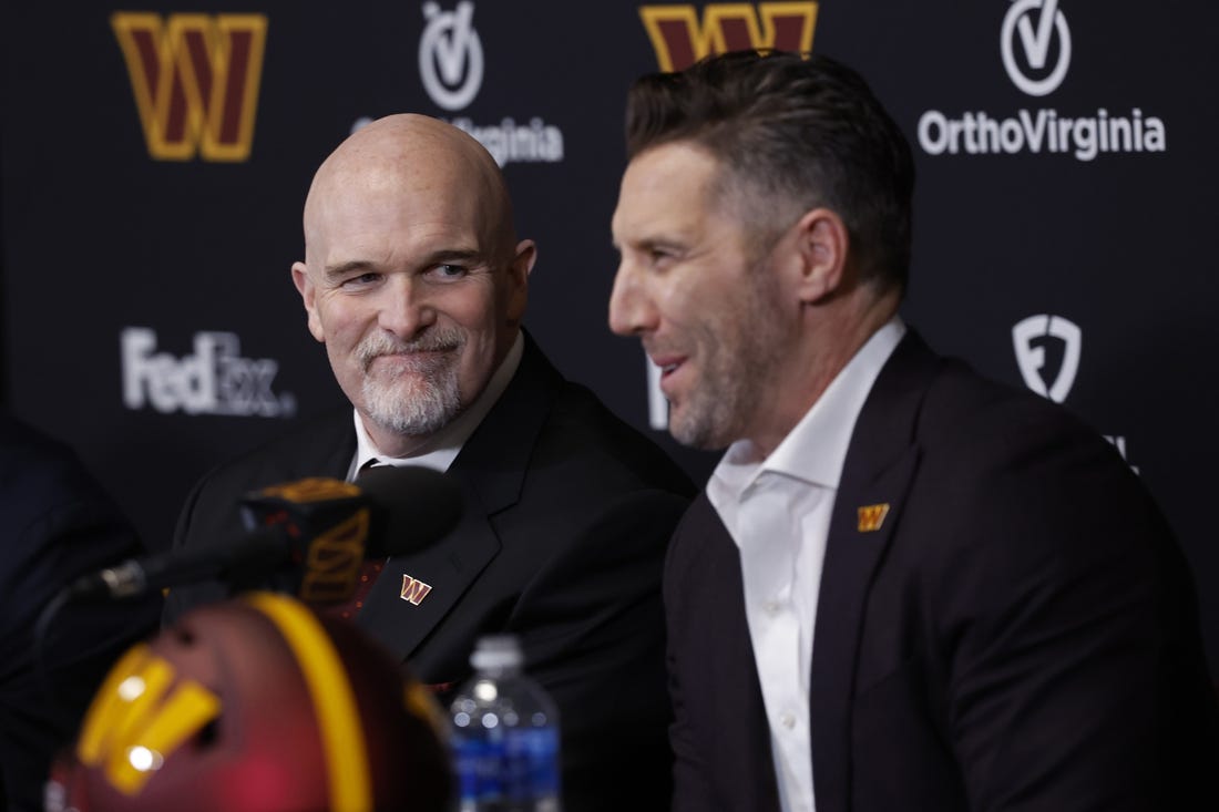 Feb 5, 2024; Ashburn, VA, USA; Washington Commanders head coach Dan Quinn (L) smiles as Commanders general manager Adam Peters (R) speaks during Quinn's introductory press conference at Commanders Park. Mandatory Credit: Geoff Burke-USA TODAY Sports